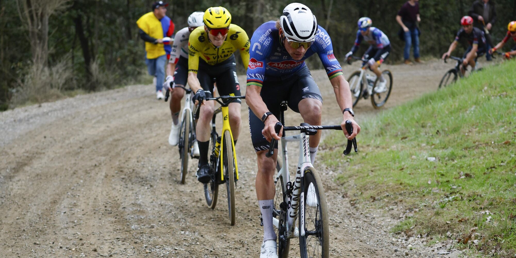 Mathieu van der Poel in yellow jersey leading on gravel road at Tirreno-Adriatico