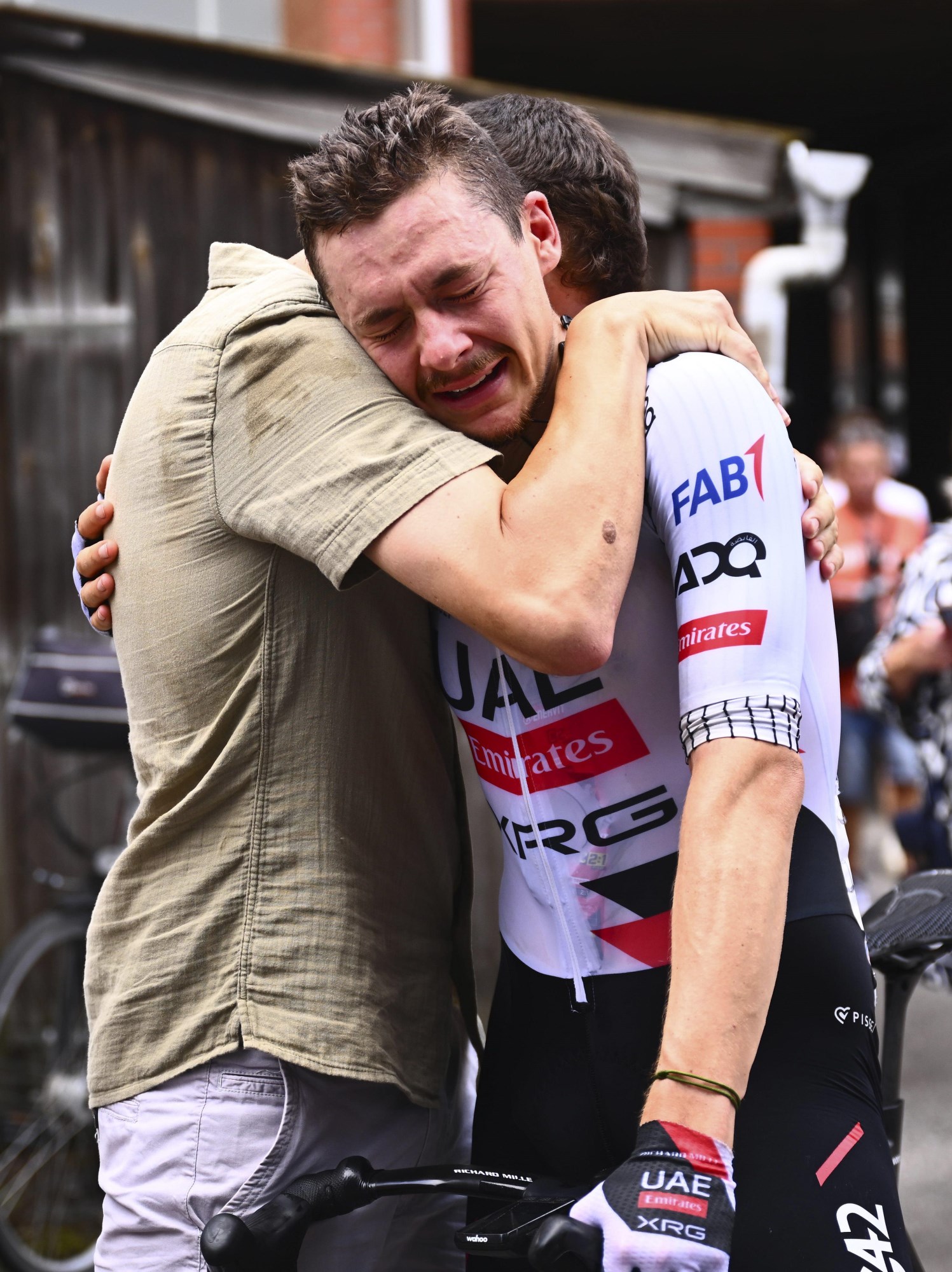 Rune Herregodts of UAE Team Emirates celebrating Belgian National Championship victory with emotional embrace