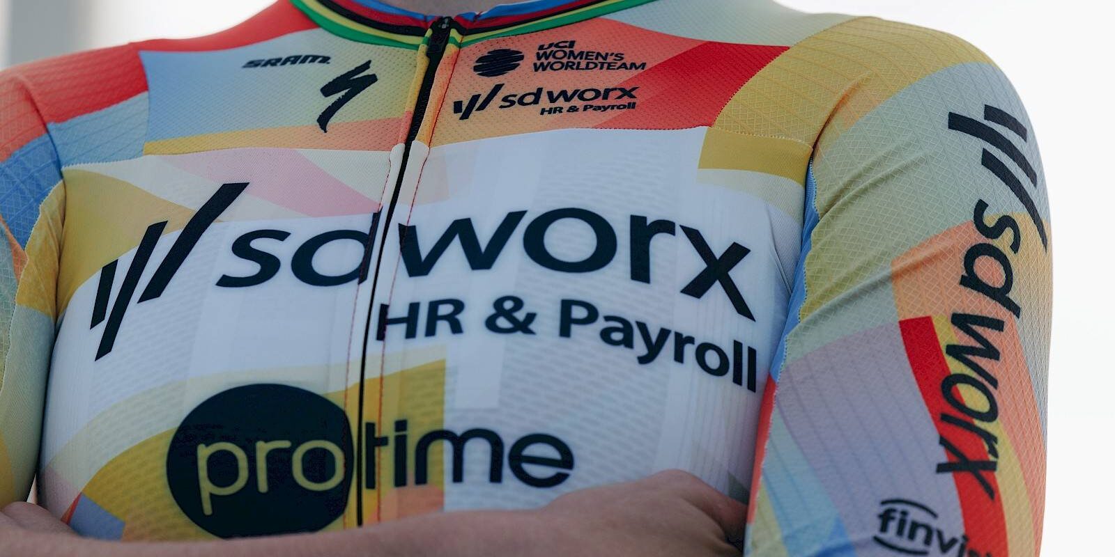 Close-up of cyclist wearing SD Worx HR & Payroll team jersey with world champion rainbow bands