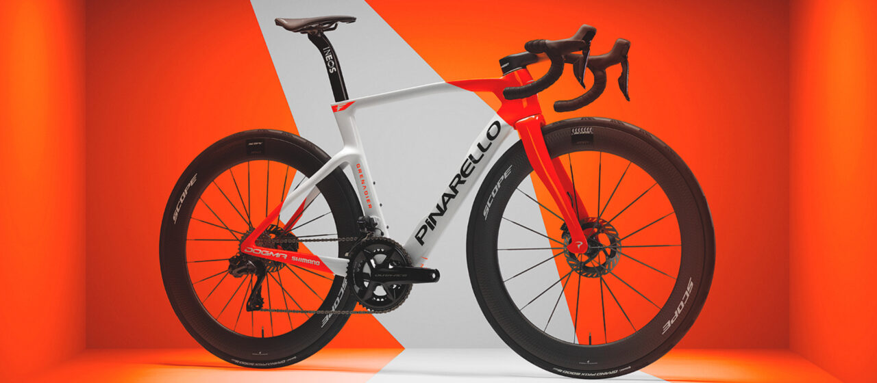Pinarello road bike in white and red colorway with deep-section wheels on orange geometric background