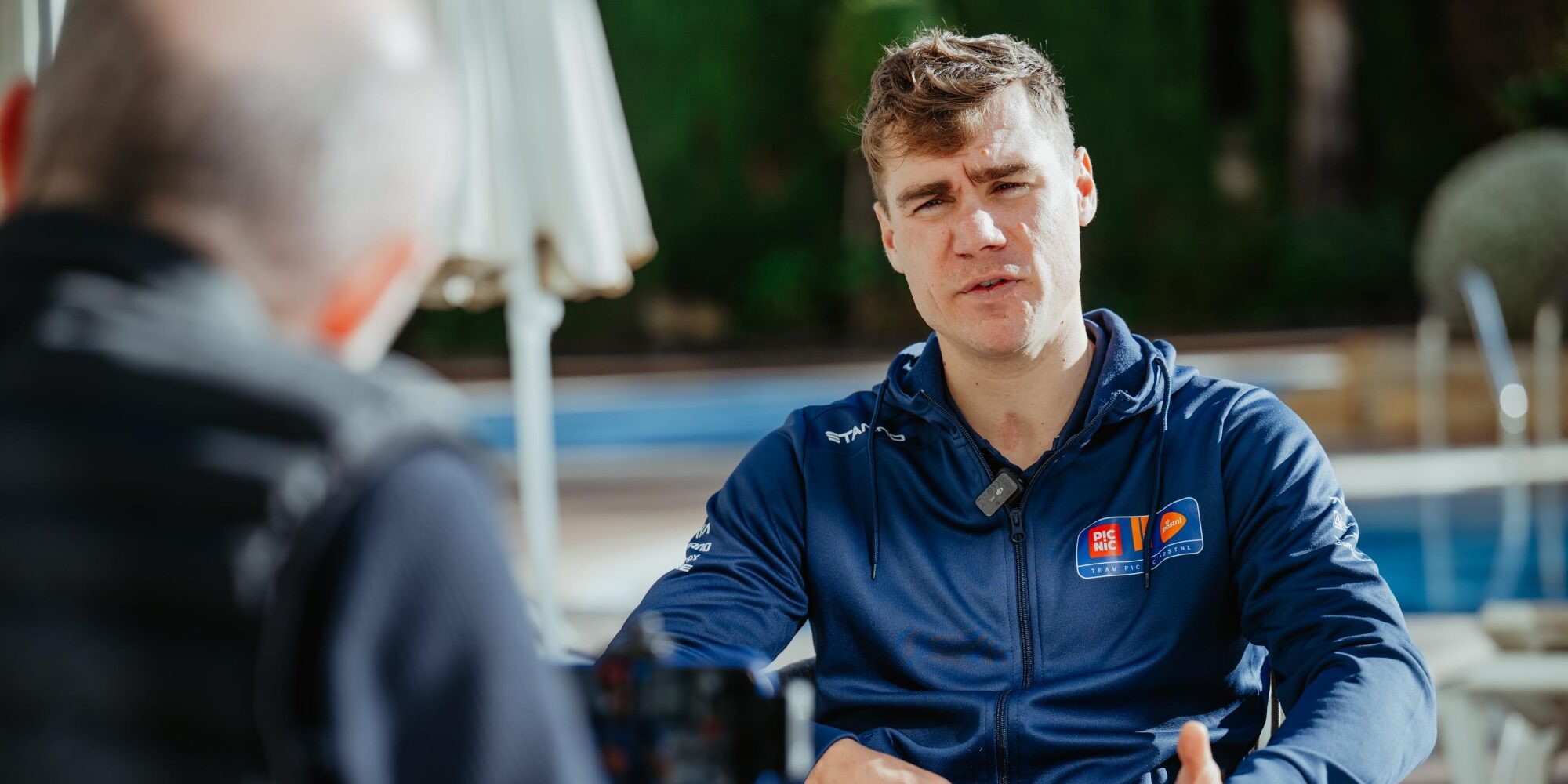 Fabio Jakobsen in Team Picnic PostNL blue jacket during press interview