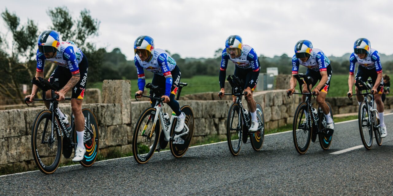 Five cyclists in aerodynamic time trial position riding in formation on a road