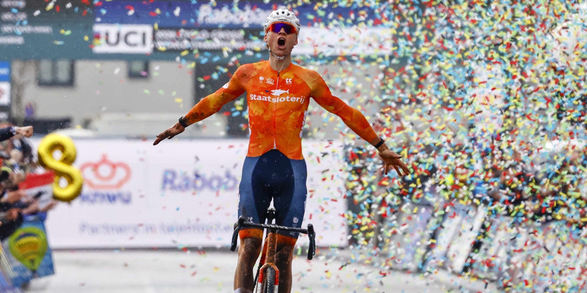 Mathieu van der Poel celebrating victory in orange Dutch jersey at UCI Cyclocross World Championships