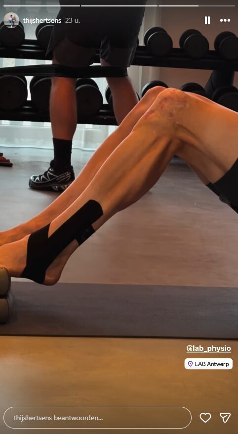 Cyclist performing rehabilitation exercise in gym with leg elevated and kinesiology tape applied